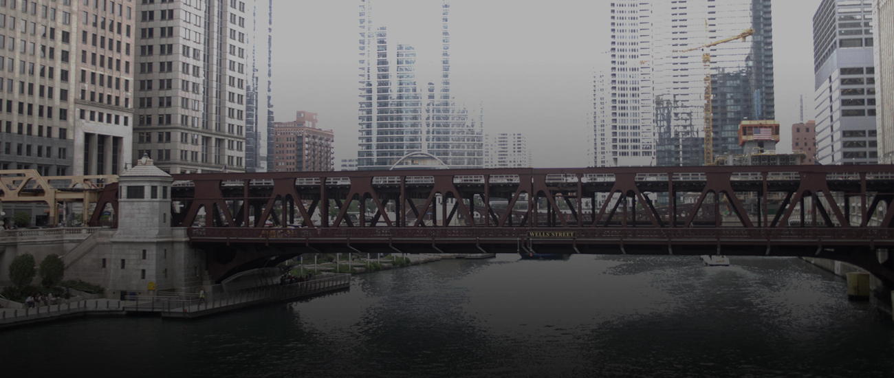 A scenic view of a bridge spanning across a tranquil river